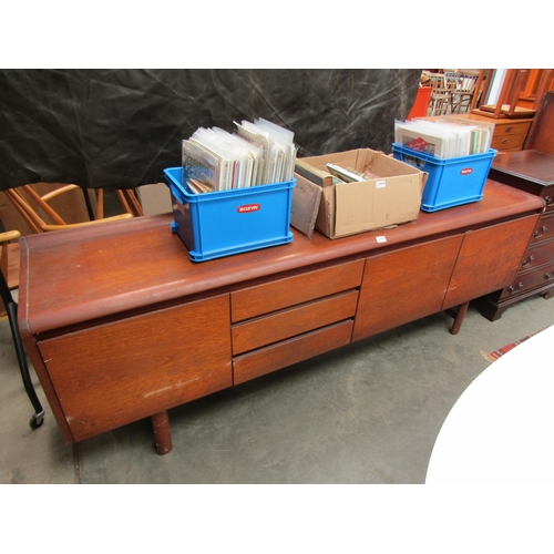 2419 - A 1970's teak sideboard, twin cupboard, three drawers flanked by full flap cupboard, 208cm long