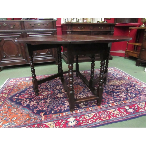 4058 - An 18th Century oak oval top gate-leg dining table, the rising leaves over a single end drawer on bo... 