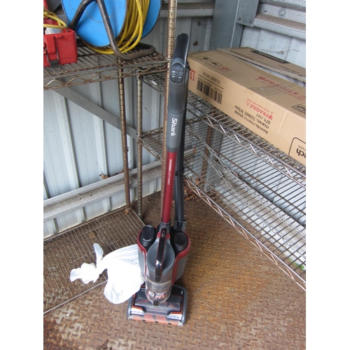 A Shark Duo Clean cordless vacuum cleaner with two batteries and charger