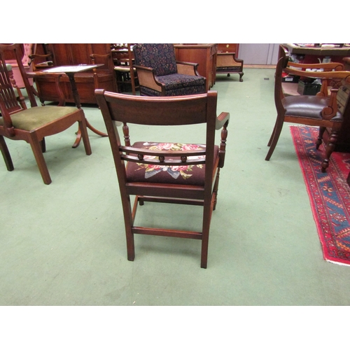 4016 - A George III flame mahogany Suffolk ball back armchair, the reeded arms on turned supports and fore ... 