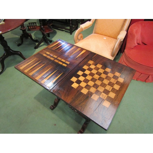 4065 - A Circa 1840 rosewood games/work table, the fold over swivel top with inlaid backgammon/chess and cr... 