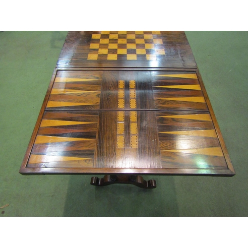 4065 - A Circa 1840 rosewood games/work table, the fold over swivel top with inlaid backgammon/chess and cr... 