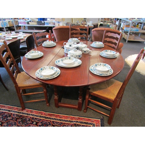 1105 - An 18th Century style circular top gateleg dining table, the rising leaves over turned legs joined b... 