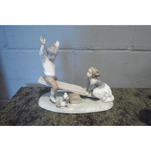 1094 - A Lladro figurine of young girl and boy on seesaw, 20cm tall