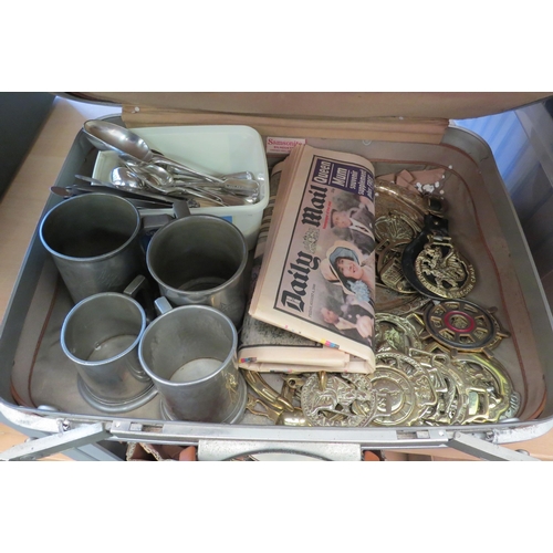 1124 - A suitcase with mixed contents including horse brasses, pewter tankards and plated cutlery