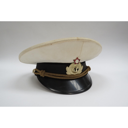 8135 - A quantity of USSR Russian Soviet peaked headwear including two Naval officer’s caps, two sailor’s h... 