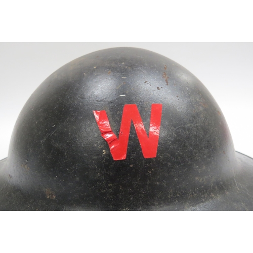 8139 - A WWII British Brodie helmet, the shell re-painted in black to outside with applied 'W' (Warden) sti... 