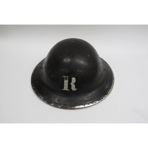 8144 - A WWII British Home Front Rescue Party Steel Helmet, black with stencilled white “R” to the centre o... 