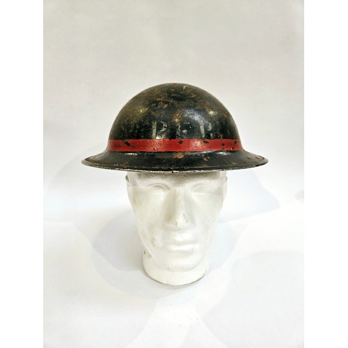 8103 - A WWII British Home Front steel helmet, black with stencilled indistinct lettering in white PFR / PE... 