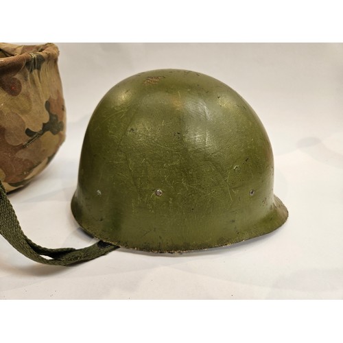 8102 - A US Vietnam War era helmet with liner and camouflage cover