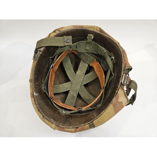 8102 - A US Vietnam War era helmet with liner and camouflage cover