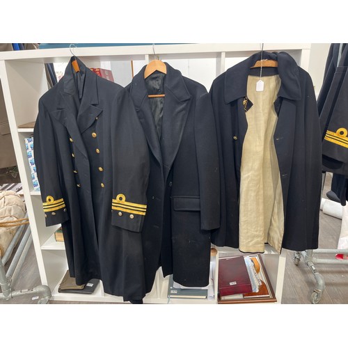 8157 - Two Royal Navy great coats including Bakelite buttoned, together with a cloak (3)