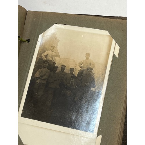 8177 - A WWII German postcard album with approx. 50 military postcards, together with an empty album