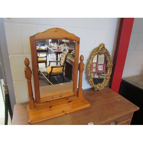 1087 - A pine dressing table mirror and an oval gilt framed mirror