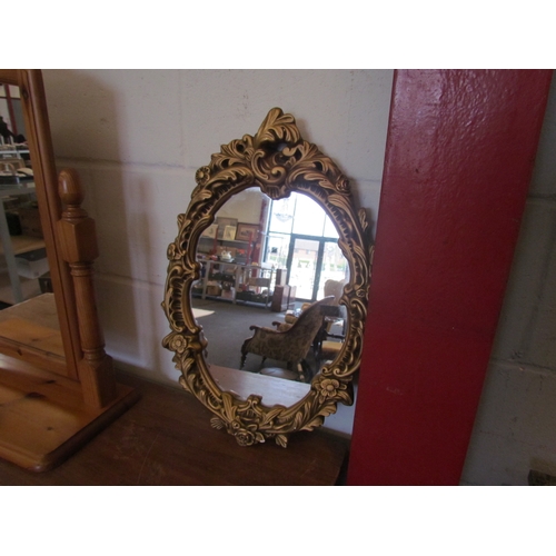 1087 - A pine dressing table mirror and an oval gilt framed mirror