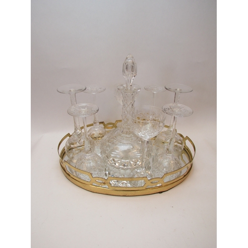 1151 - A mirrored tray with brass gallery, crystal glass decanter and eight crystal wine glasses