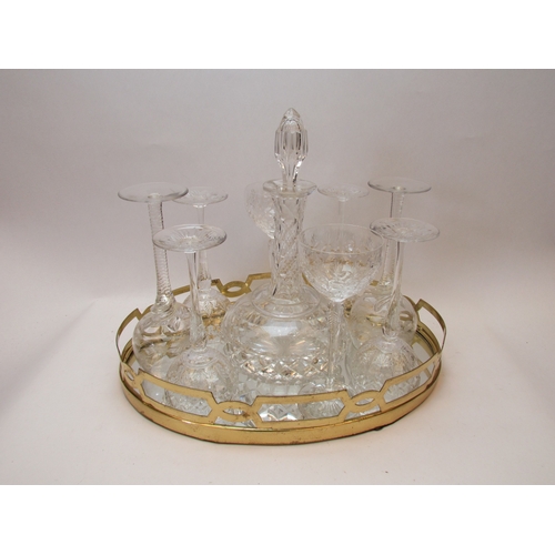 1151 - A mirrored tray with brass gallery, crystal glass decanter and eight crystal wine glasses