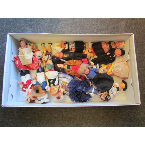 1160 - A box of assorted plastic dolls wearing various costumes