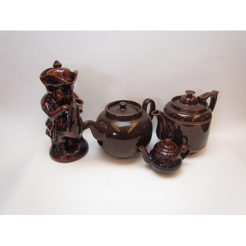 1202 - Four brown treacle glazed teapots including a figural example, some a/f  (E)  £10-20