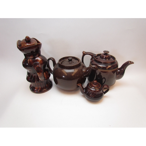 1202 - Four brown treacle glazed teapots including a figural example, some a/f  (E)  £10-20