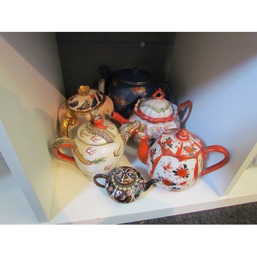 1216 - Ten teapots to include Victorian example on stand, crinoline lady, etc