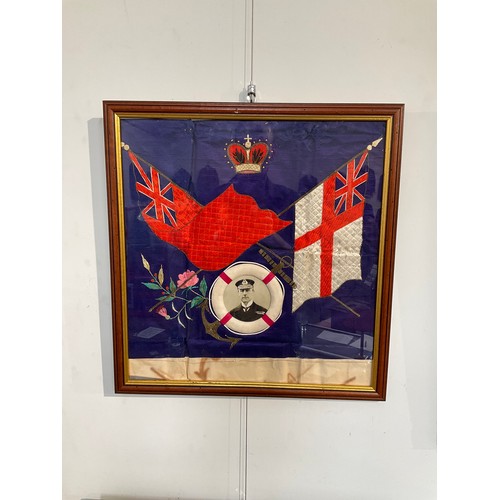 8369 - An early 20th Century silk embroidery, crossed white and red ensign flags with lifebelt with photogr... 