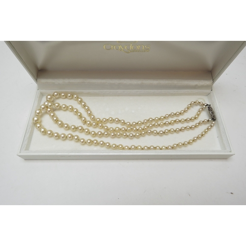 1247 - A double strand pearl necklace with 9ct white gold clasp set with a diamond chip  (E)  £40-60