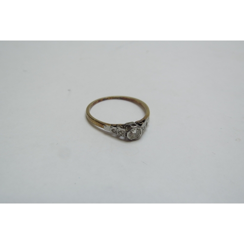 1253 - A solitaire diamond ring with diamond set shoulders, stamped 18ct/plat. Size Q/P, 1.8g  (C)