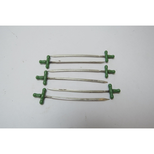 1256 - A set of six silver cocktail sticks as sabres with green finials