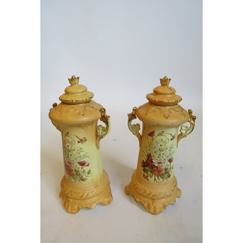 1362 - A pair of Austrian blush ground lidded canisters painted with still-life of flower posies (lids a/f)... 