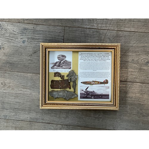 8564 - A collection of WWII Hurricane aircraft crash relics, displayed within a glazed frame with crash det... 