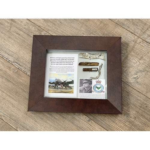 8567 - A collection of WWII Lancaster aircraft crash relics, ED694, displayed within a glazed frame with cr... 