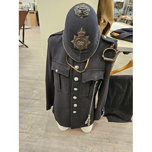 8147 - A 1940's Metropolitan Police uniform consisting of helmet, jacket, trousers, handcuffs and whistle