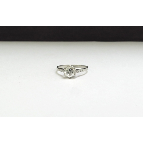 9012 - A platinum set diamond solitaire ring, 1ct approx flanked by diamond set shoulders. Size N, 2.3g