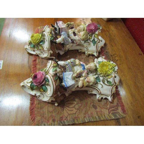 4113 - A pair of Victorian Continental porcelain wall pockets, boys and girls with applied floral design, 3... 