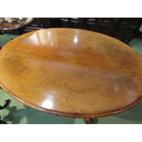 4068 - A Victorian walnut and rosewood oval-top loo table, on foliate carved quatreform base, 70cm tall x 1... 