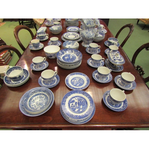 4110 - A good quantity of assorted blue and white, mostly Willow Ware comprising cups, saucers, plates, jug... 