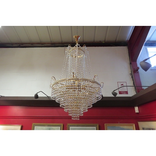 4485 - A Swarovski style crystal chandelier, six drop tier, eight lights. 
61cm diameter (inc branches), 10... 