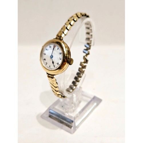 8179 - A 9ct gold cased wristwatch with white enamelled dial, Arabic numerals. Crack to enamel.  (R)  £70  ... 