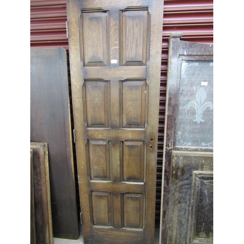 3597 - An oak eight panel door, 196cm x 63cm