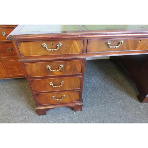 1112 - A George III style flame mahogany twin pedestal desk of eight drawers over bracket feet, leather top... 