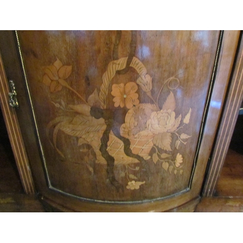 1010 - An Edwardian walnut sideboard, marquetry ribbon with swag and foliage, the bow fronted central door ... 