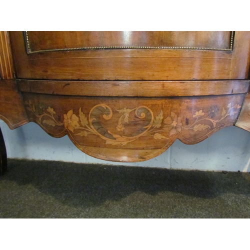 1010 - An Edwardian walnut sideboard, marquetry ribbon with swag and foliage, the bow fronted central door ... 