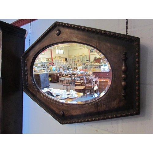 1012 - An early 20th Century oak framed bevel edged oval wall mirror, 56cm x 75cm