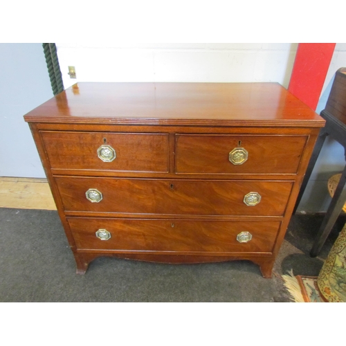 1074 - A 19th Century oak chest of two short over two long drawers, octagonal brass handles, on outswept br... 