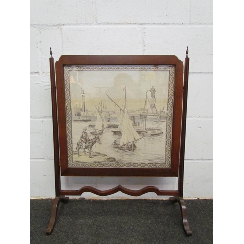 1080 - A Georgian mahogany fire screen with tapestry panel depicting sail ships and man on a donkey