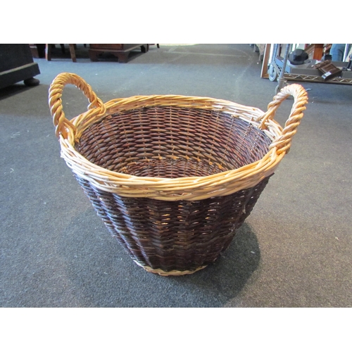 1081 - A wicker twin handled log basket, 45cm diameter