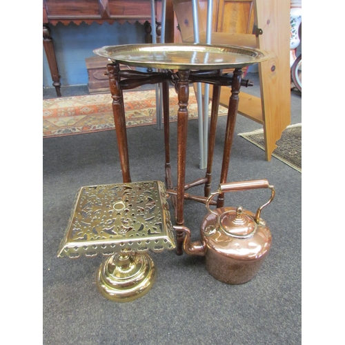 1082 - A Victorian copper kettle together with a brass trivet and an eastern folding table (3)