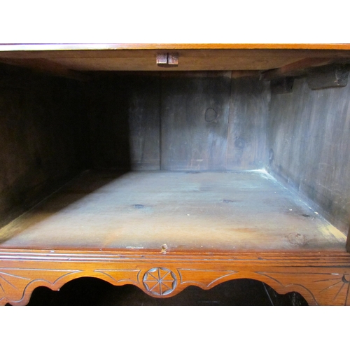 1107 - An Edwardian mahogany carved sideboard, three drawers above three cupboards with carved floral doors... 