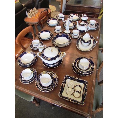 1114 - A Zsolnay, Hungary, porcelain dinner service for eight, white ground with blue and gilt border